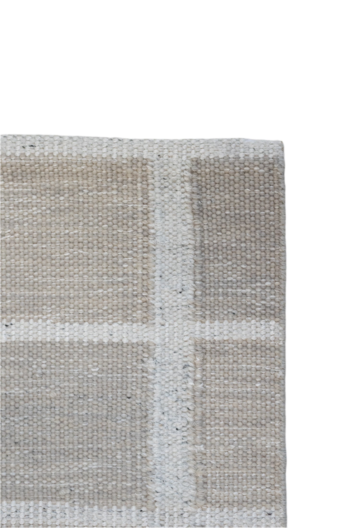 Close-up of a textured rug with a checkered pattern on a light gray background